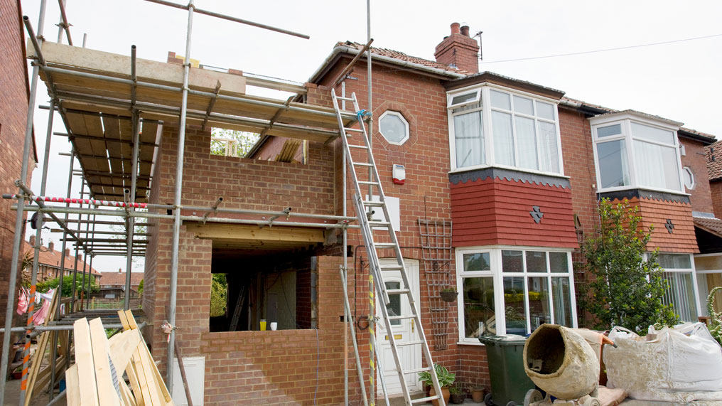 scaffolding is seen around a home extension