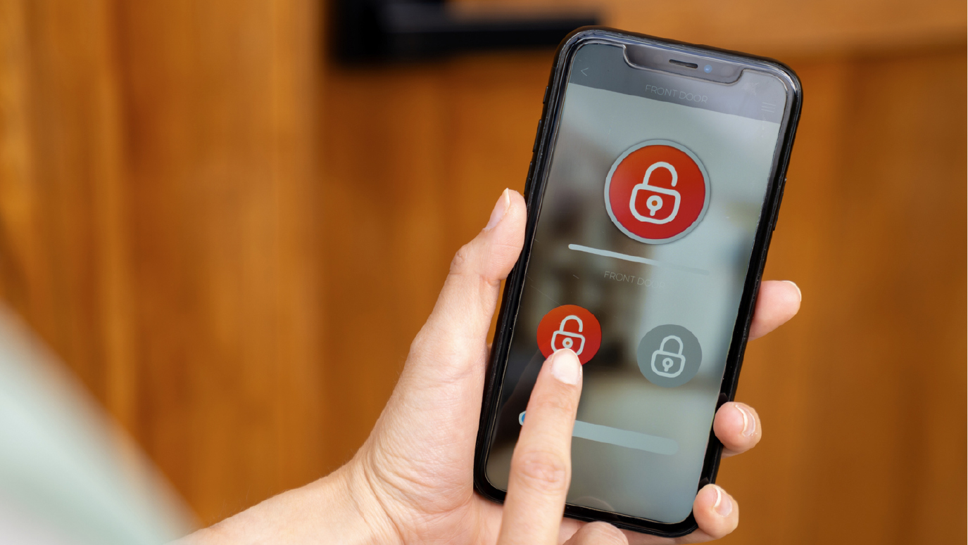 Someone using their phone to lock their front door.