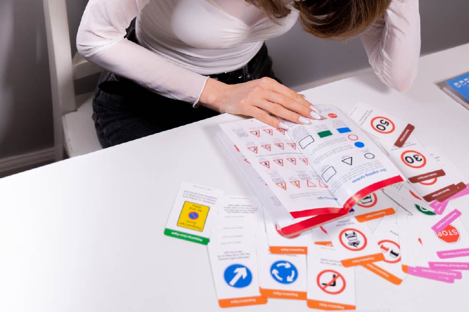A young woman studying the Highway Code for her theory test.