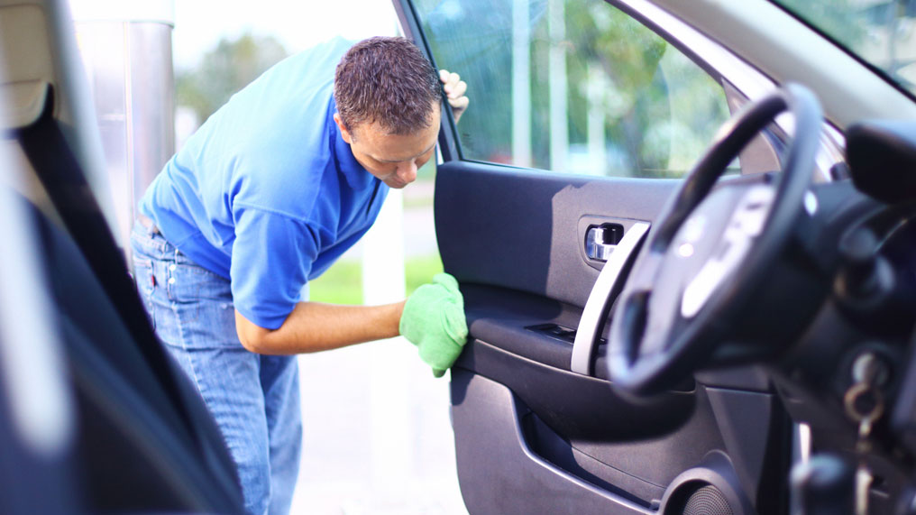 a man cleans the inside of a car