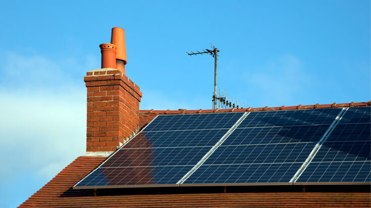 The roof of a home is fitted with solar panels.