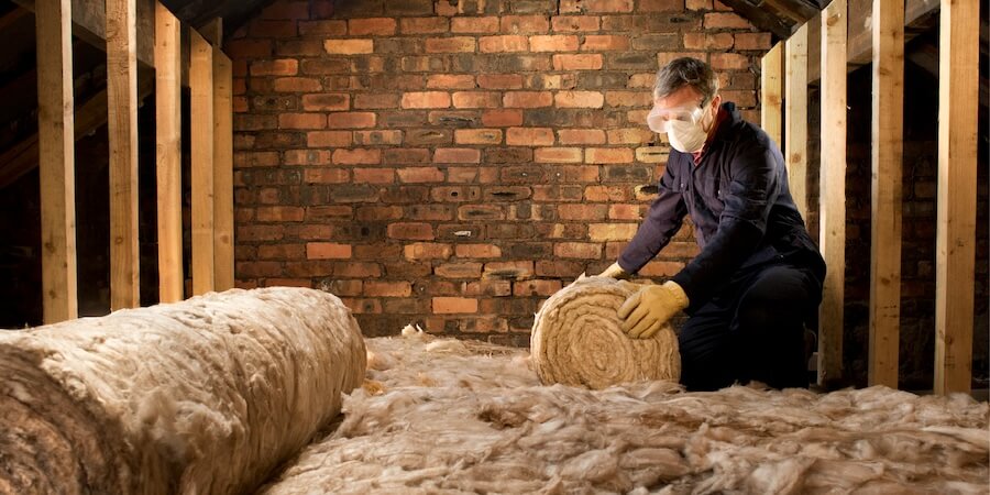 Someone insulating a loft.