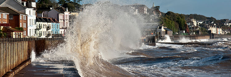 Sea waves crashing against houses